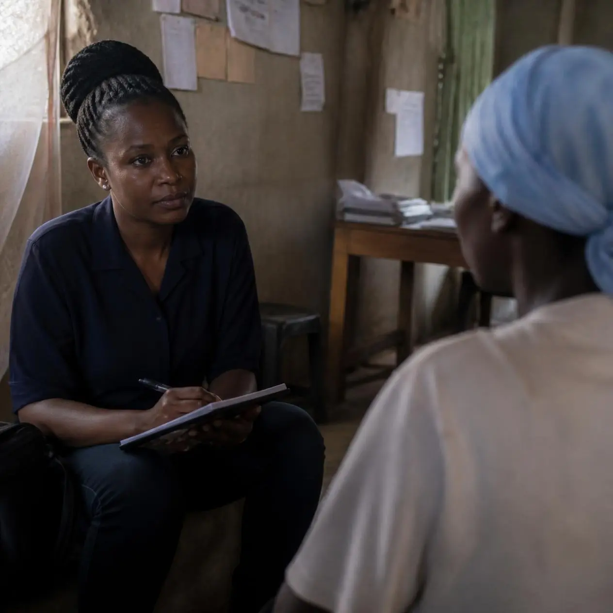 Researcher conducts a private interview while protecting the participant’s identity, illustrating concerns around confidentiality, data security, and potential harm.